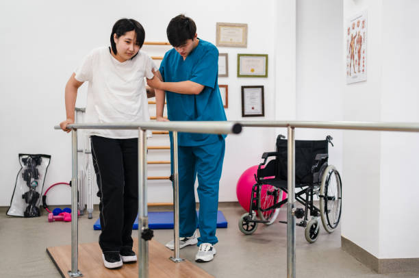 istock Young patient doing physiotherapy at a clinic with help of a therapist 1362933217