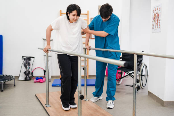 istock Young patient doing physiotherapy at a clinic with help of a therapist 1362933348