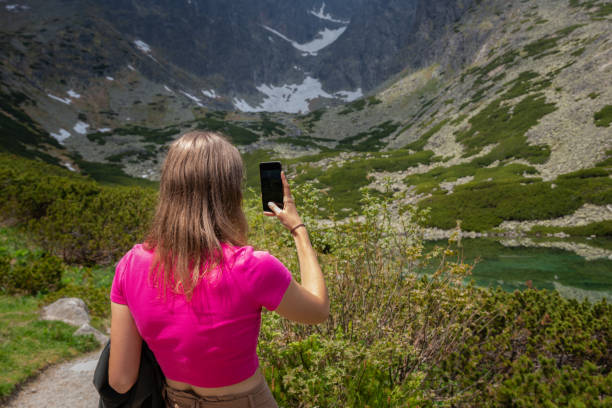 istock Beautiful blonde long-haired phone, taking selfies with a mobile phone 1362934203