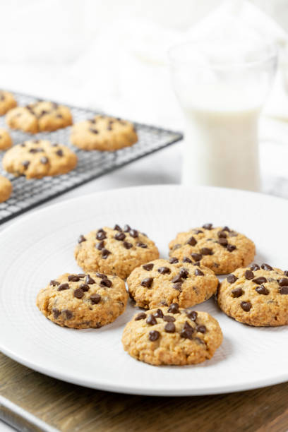 istock Delicious Whole Wheat Chocolate Chip Cookies set on white cafe table. 1362934420