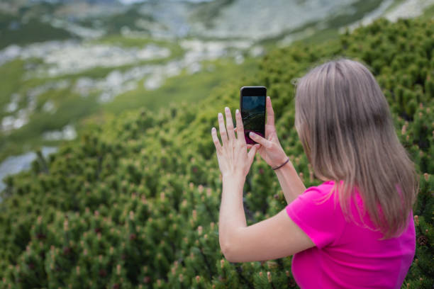 istock Beautiful blonde long-haired phone, taking selfies with a mobile phone 1362938307