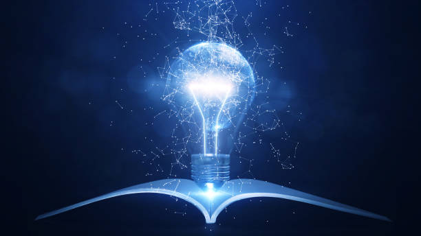 istock Learning from books or textbooks and the internet around the world creates new ideas. An interconnected polygon that surrounds a glowing light bulb with a book underneath. dark silver background. 1362939931