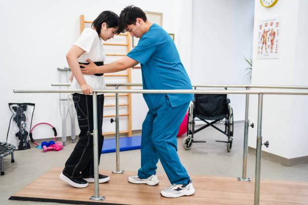 Young patient doing physiotherapy at a clinic with help of a therapist Young patient doing physiotherapy at a clinic with help of a therapist occupational therapy photos stock pictures, royalty-free photos & images