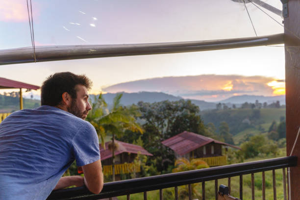 istock Horizontal side view of latin american man sightseeing from viewpoint valley background. 1362942762