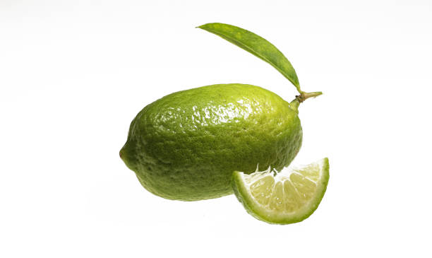 istock Green lemon leaf and slice isolated on a white background with clipping path. 1362943643
