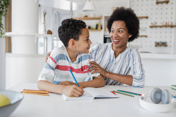 istock Mother helping her son with homework 1362943690