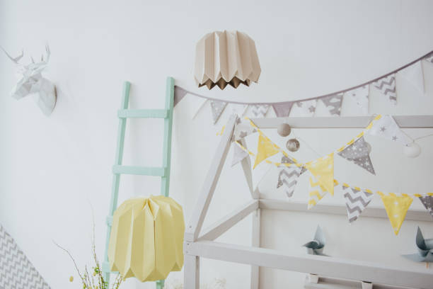 istock Easter decoration. Easter eggs with wooden feeder and mimosa. 1362944294