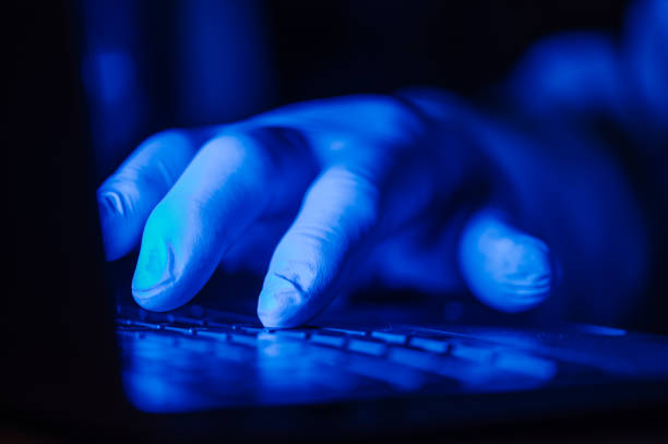 istock Hand with protective glove on a laptop keyboard 1362945195