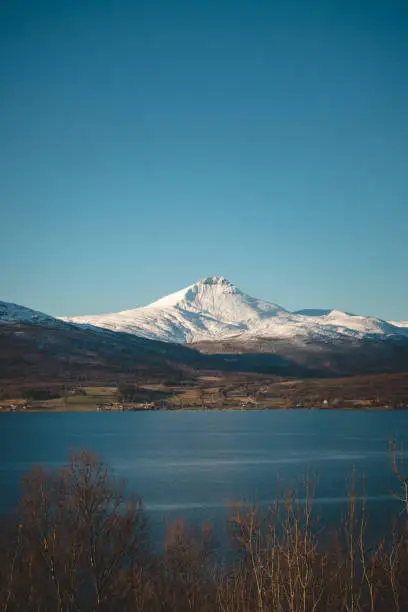 Breathtaking wildlife of the northernmost part of Norway, Finnmark. Snow-capped hills along with Balsfjorden Bay. The Scandinavian landscape. Discovering the polar region. Tromso region.