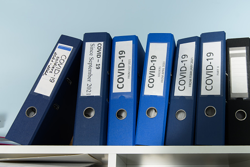 Shelves are full with folders and files of medical record, patient information.