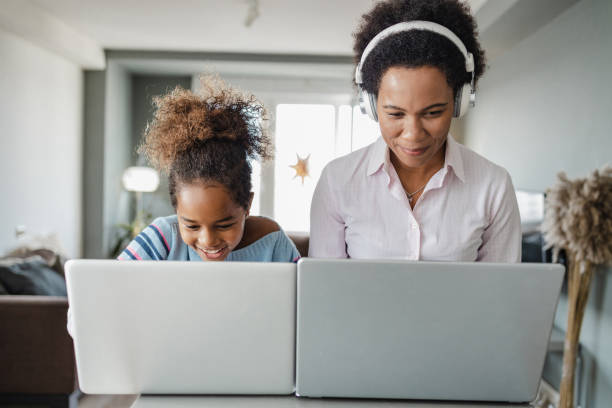 istock Mother and daughter using their laptops at home 1362947742
