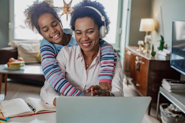 istock Mother is working from home and her daughter is embracing her 1362947861