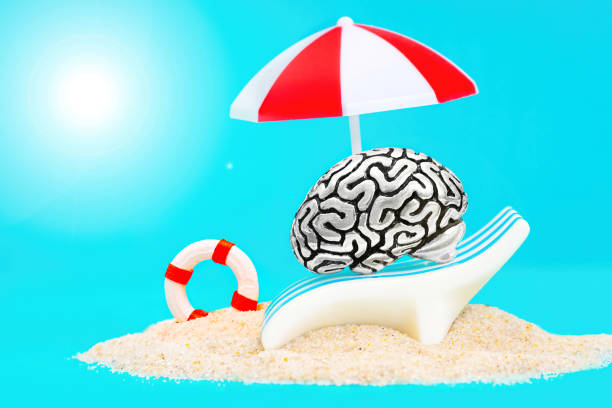 istock Human brain relaxing under a sun umbrella on a sandy beach 1362947881