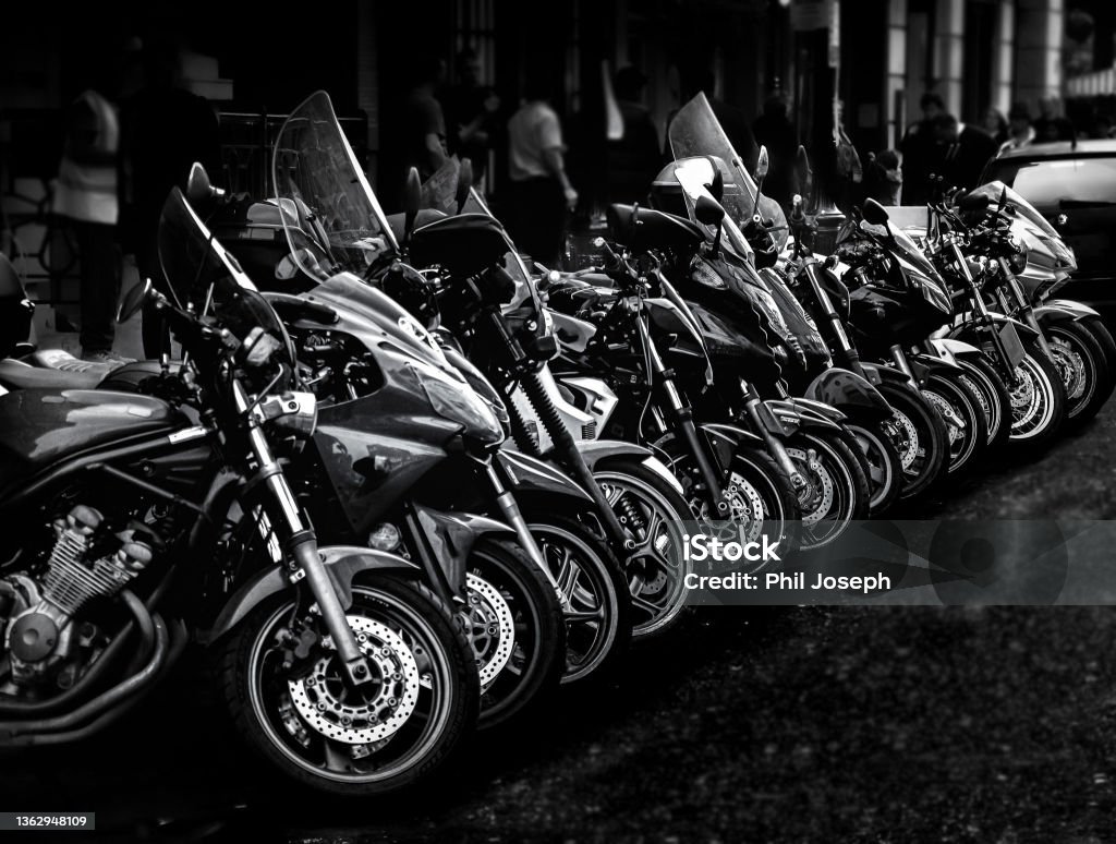 Linear Motorbikes in a row in black and white Motorcycle Stock Photo