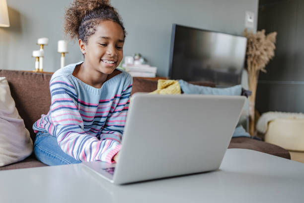 istock Little girl using laptop at home 1362948263