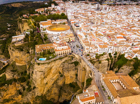 Aerial view of rocky landscape of Ronda with buildings and Bridge, Andalusia, Spain