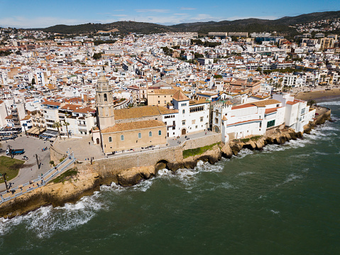 Landscape of picturesque Spanish town of Sitges with Monastery on Mediterranean seaside