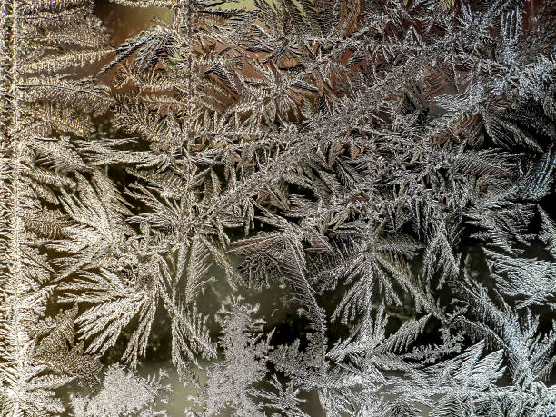 istock beautiful frosty patterns on the window glass 1362950665