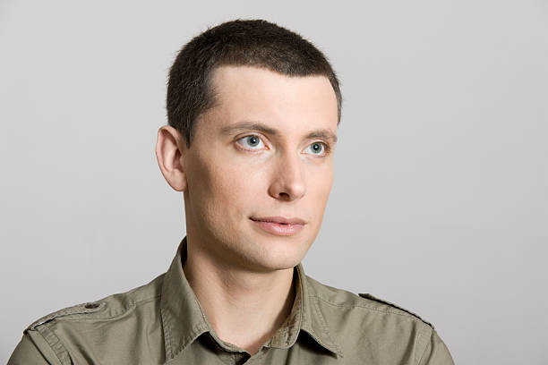 istock pensive young cute guy looks into the distance 136295088