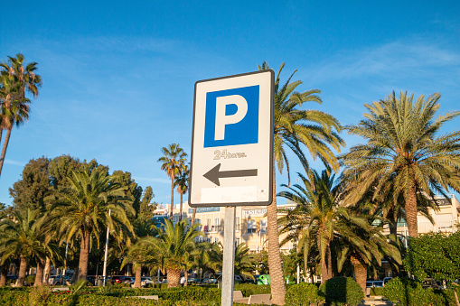 Parking Sign in Valencia, Spain, with shop names visible in the background