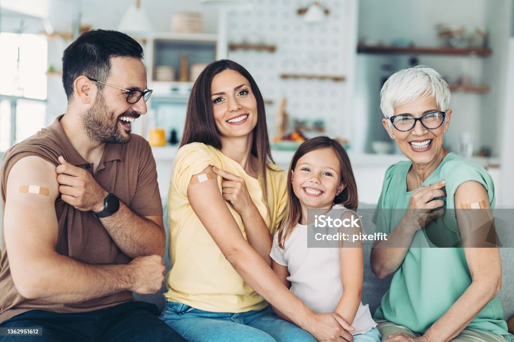 Family vaccination Portrait of a family with a child with adhesive bandages after covid-19 vaccination Vaccination Stock Photo