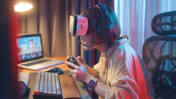 virtual reality gaming and metaverse concept, women have fun playing vr games at home - metaverse stockfoto's en -beelden
