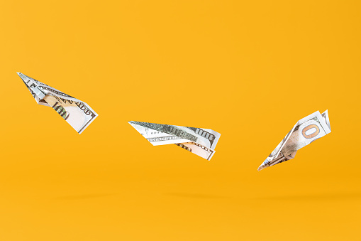 Three airplanes making of dollar money flying on yellow background