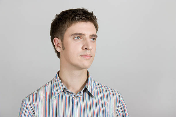 istock pensive young cute guy looks into the distance 136295433