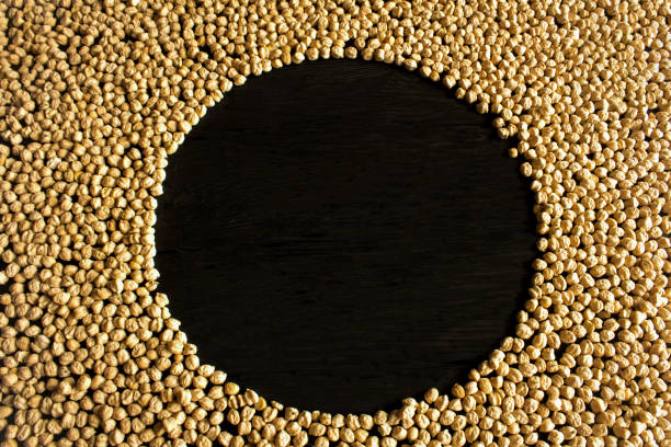 Raw chick-pea on the black background. Top view. Copy space.