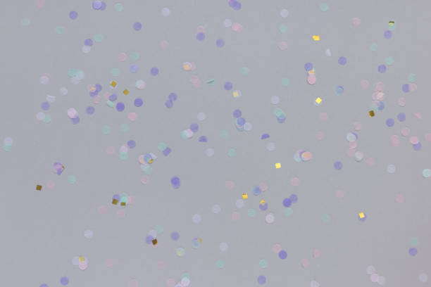istock Multicolored confetti on gray background. Carnival and festive holiday concept 1362955610