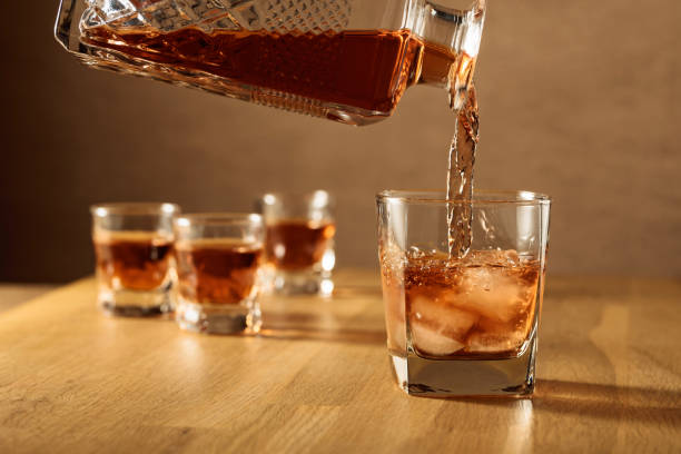 istock Whiskey is poured into a dammed glass with ice. 1362956056
