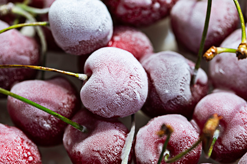 Extreme closeup of frozen cherries.