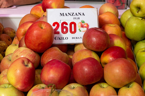 Apples at Mercado Central (Central Market) in Valencia, Spain, with an illustration visible
