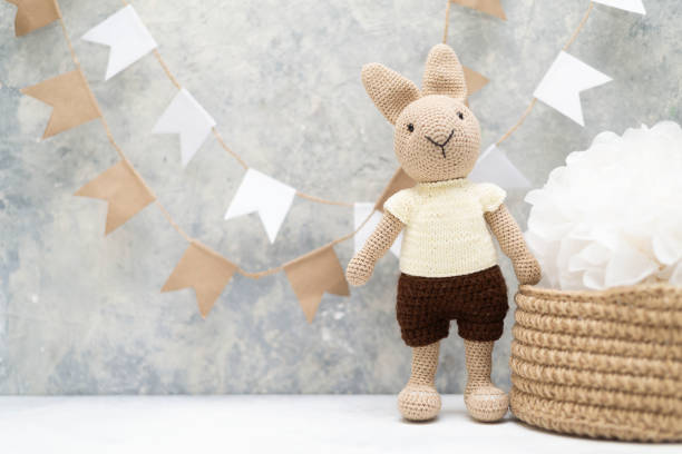 istock knitted hare with a knitted basket and flags on the wall 1362958113