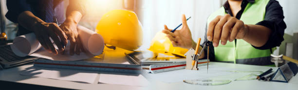 istock Two colleagues discussing data working and tablet, laptop with on on architectural project at construction site at desk in office 1362958216