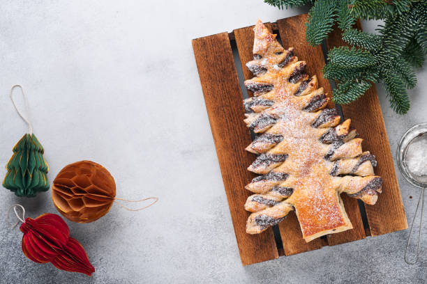 istock Puff pastry Christmas tree with chocolate paste, sprinkled with powdered sugar on a gray background. Christmas or Xmas pastries. Top view. Copy Space 1362958816