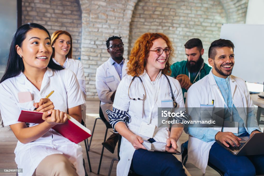 Group of happy doctors on seminar in lecture hall at hospital Medical Student Stock Photo