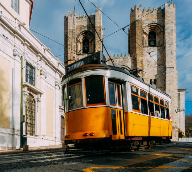 istock Se Lisbon Cathedral with a traditional yellow tram 1362962961