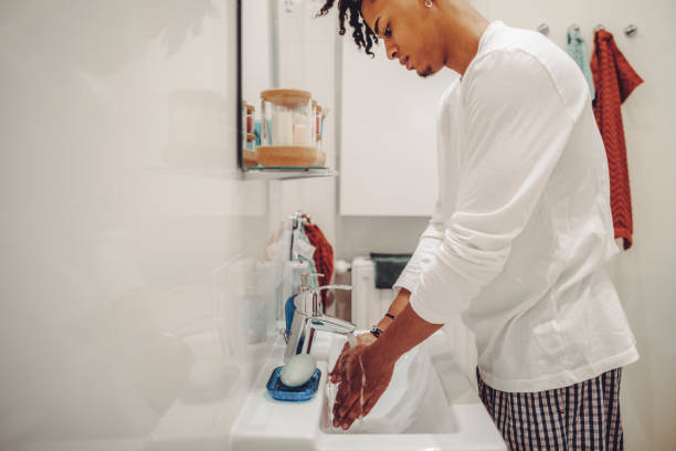 istock At home - young man brushing his teeth 1362964173