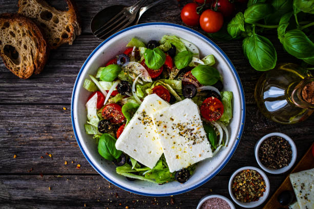 istock Feta cheese salad on wooden table 1362965714