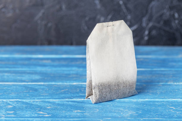 istock tea bag with herbs for tea on wooden table 1362966124