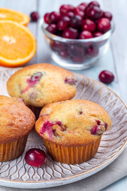 istock Cranberry orange muffins on wooden plate, vertical 1362968336