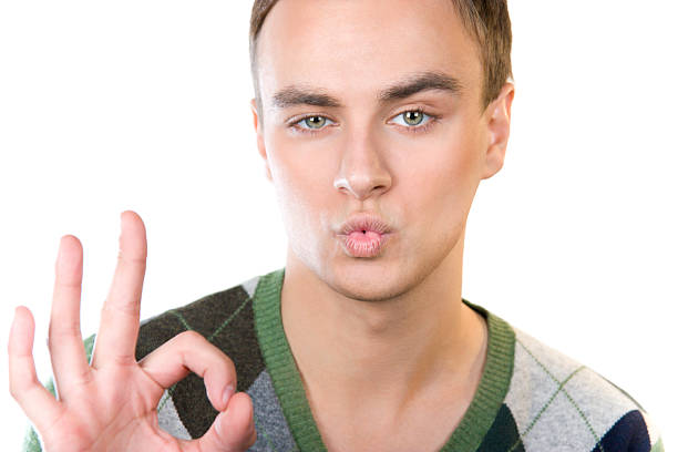 young cute guy showing okay sign stock photo