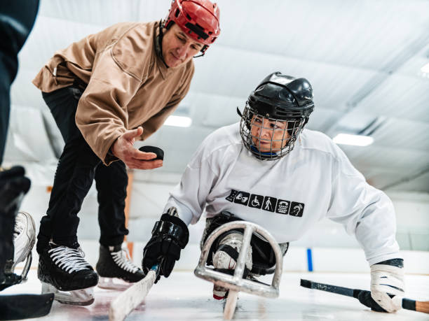 istock Latin woman and her trainer practising sledge hockey 1362968853