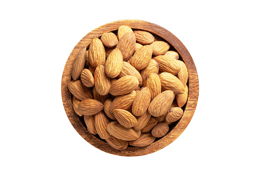 almond nuts peeled raw in wooden bowl isolated on white. healthy food, top view.
