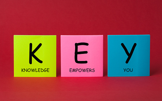 Knowledge Empowers You (KEY) message with color sticky notes on red background.