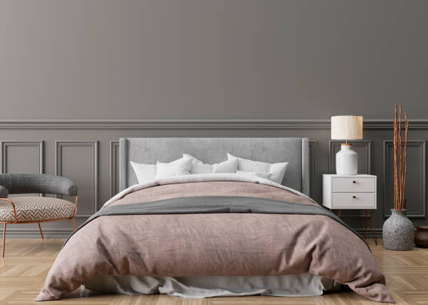 istock Empty grey wall in modern and cozy bedroom. Mock up interior in classic style. Free space, copy space for your picture, text, or another design. Bed, armchair, parquet floor. 3D rendering. 1362971750
