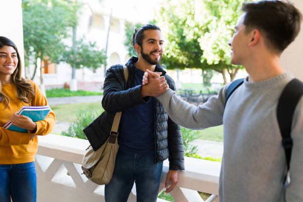 istock College friends saying hi at campus 1362972009
