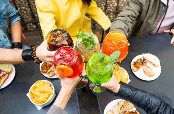 幸せな時間に一緒に楽しみながらカクテルドリンクで乾杯する友人 - パーティーの人々の概念 - 食前酒 ストックフォトと画像