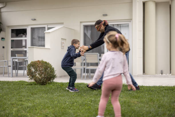 istock Young father and two kids playing hide and seek in back yard 1362976658